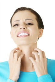 woman scratching face and hoping to discover what causes her itchy skin