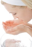 beautiful woman washing her face to illustrate Skin Care Tips